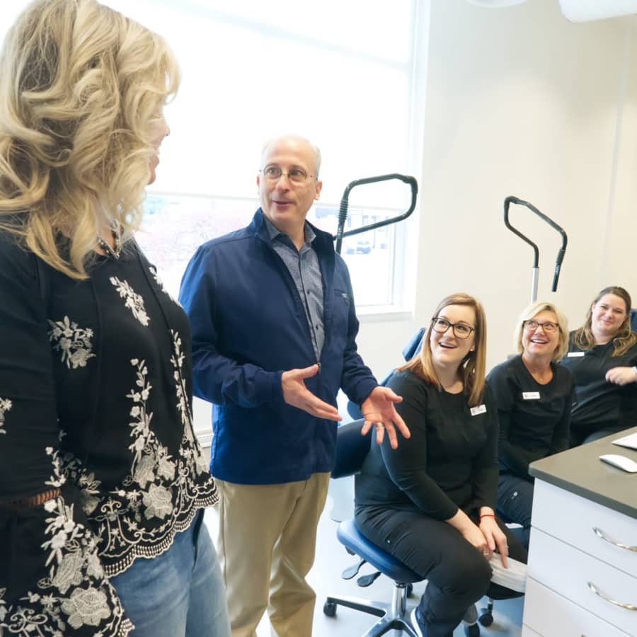Dr. Howard Smiling with Team Members